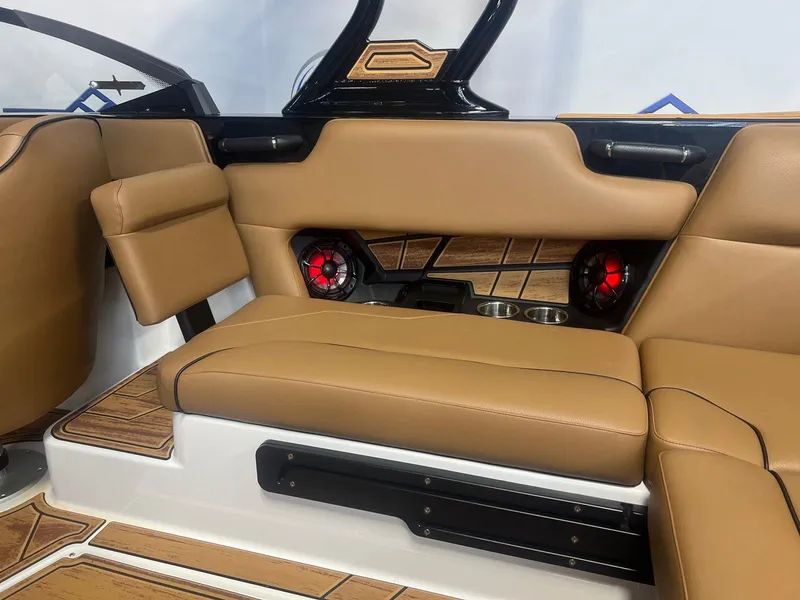 Slide: The Image of 2025 Moomba Max interior with tan leather seats, wood accents, and red speakers. - 15