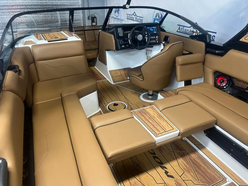 Slide: The Image of 2025 Moomba Max boat interior with tan seating and modern dashboard. - 17