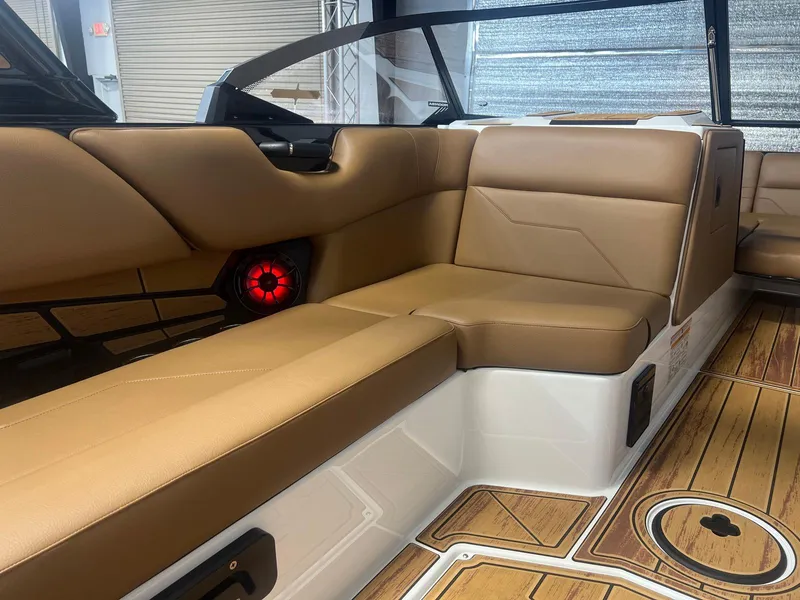 Slide: The Image of 2025 Moomba Max interior with tan leather seating and wood-style flooring. - 18