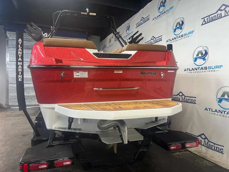 Slide: The Image of 2025 Moomba Max boat in showroom, red exterior, Atlanta Marine branding. - 8