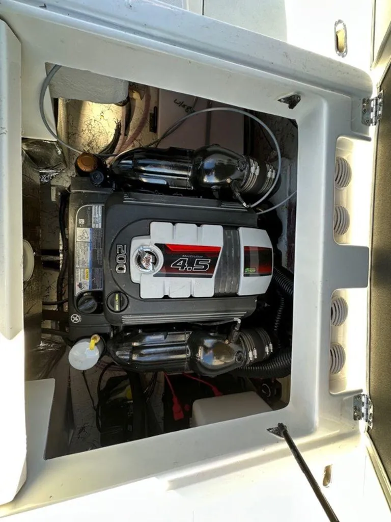 Slide: The Image of Engine compartment of 2022 Hurricane SunDeck 187 IO boat, featuring a 4.5L engine. - 10