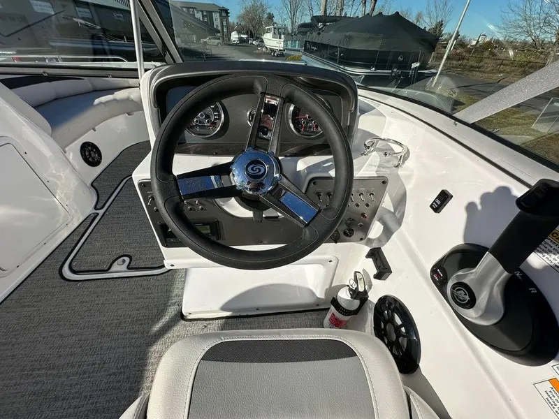 Slide: The Image of 2022 Hurricane SunDeck 187 IO boat cockpit with steering wheel and control panel. - 4