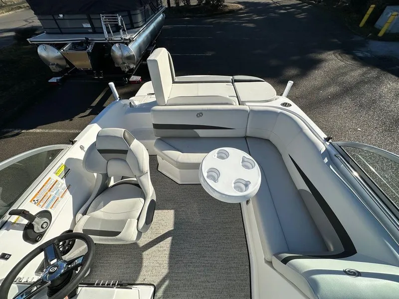 Slide: The Image of 2022 Hurricane SunDeck 187 IO boat interior with seating and steering wheel. - 6