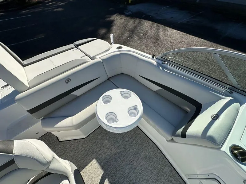 Slide: The Image of 2022 Hurricane SunDeck 187 IO boat interior with seating and cup holders. - 7