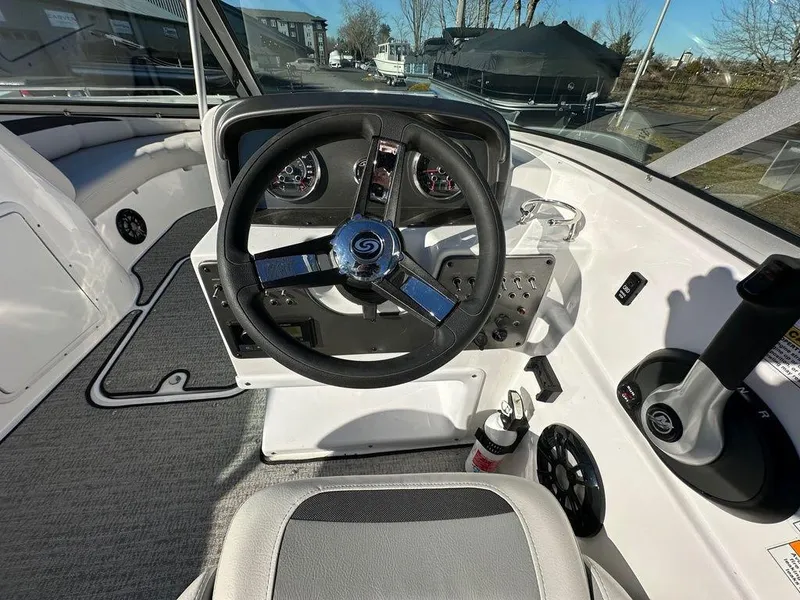 Slide: The Image of 2022 Hurricane SunDeck 187 IO boat cockpit with steering wheel and controls. - 9