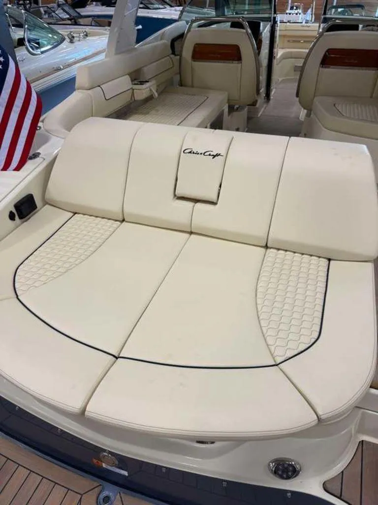 Slide: The Image of 2025 Chris-Craft Launch 31 GT boat interior with luxurious seating and American flag. - 3