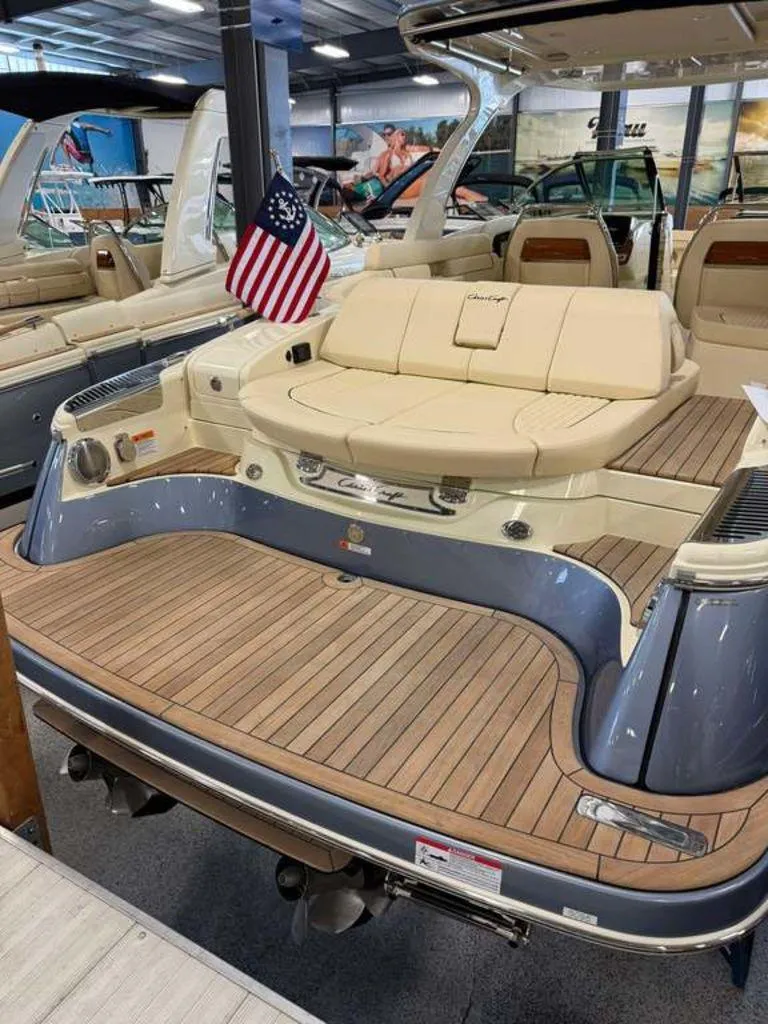 Slide: The Image of 2025 Chris-Craft Launch 31 GT boat with elegant seating and American flag display. - 4