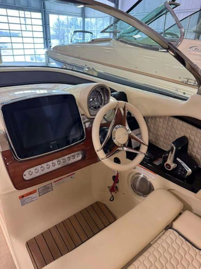 Slide: The Image of 2025 Chris-Craft Launch 31 GT cockpit with modern steering and dashboard controls. - 9