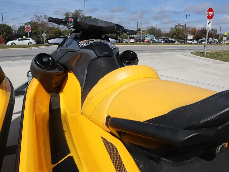 Slide: The Image of 2022 Sea-Doo GTR 230 jet ski with yellow seat, parked near a road. - 3