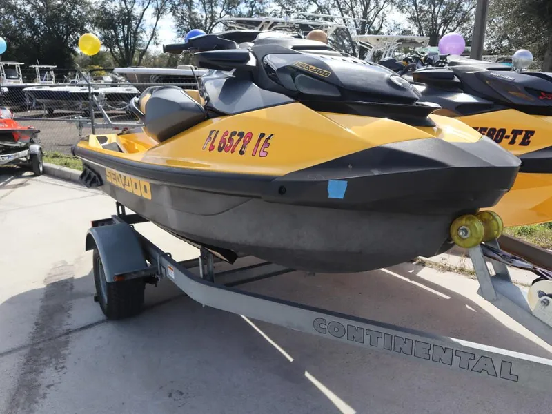 Slide: The Image of 2022 Sea-Doo GTR 230 jet ski on trailer, yellow and black, parked outdoors. - 5