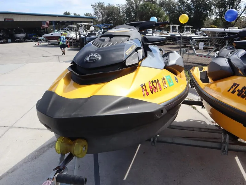 Slide: The Image of 2022 Sea-Doo GTR 230 jet ski in yellow, parked on a trailer at a dealership. - 6