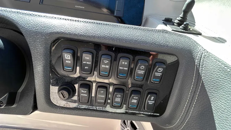 Slide: The Image of Control panel of a 2022 Regal LX6 boat with various switches. - 10
