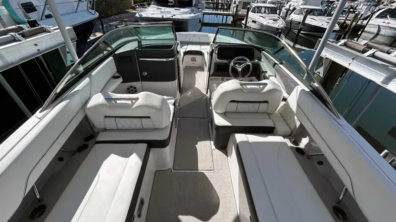 Slide: The Image of 2022 Regal LX6 boat interior with white seating and modern design. - 2