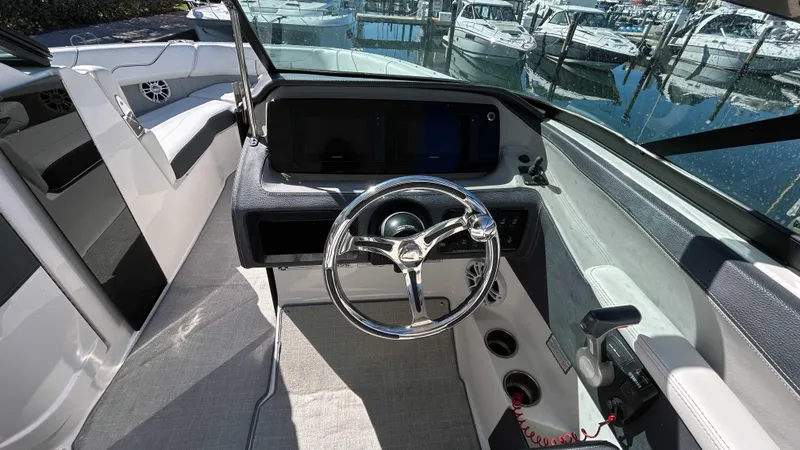 Slide: The Image of 2022 Regal LX6 boat cockpit with steering wheel and control panel. - 3