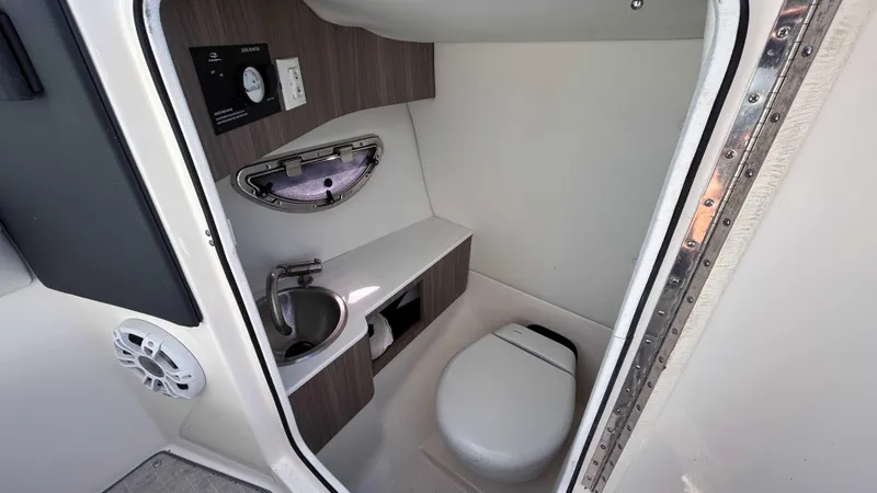 Slide: The Image of 2022 Regal LX6 boat interior bathroom with sink and toilet. - 4