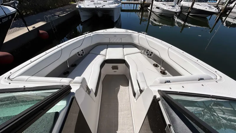 Slide: The Image of 2022 Regal LX6 boat interior with white seating, docked at marina. - 5