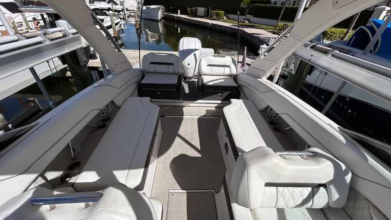 Slide: The Image of 2022 Regal LX6 boat interior with white seating and spacious layout. - 7