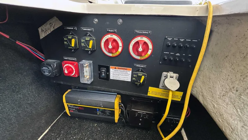 Slide: The Image of Control panel of a 2022 Regal LX6 boat with switches and wiring. - 9