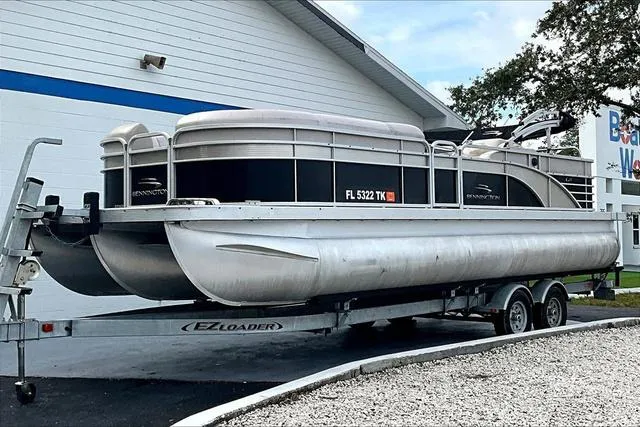 Slide: The Image of 2014 Bennington 2375 GCW pontoon boat cruising on a lake with passengers enjoying the ride. - 1