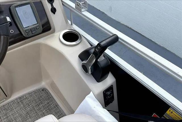 Slide: The Image of 2014 Bennington 2375 GCW boat console with throttle, cup holder, and navigation display. - 10