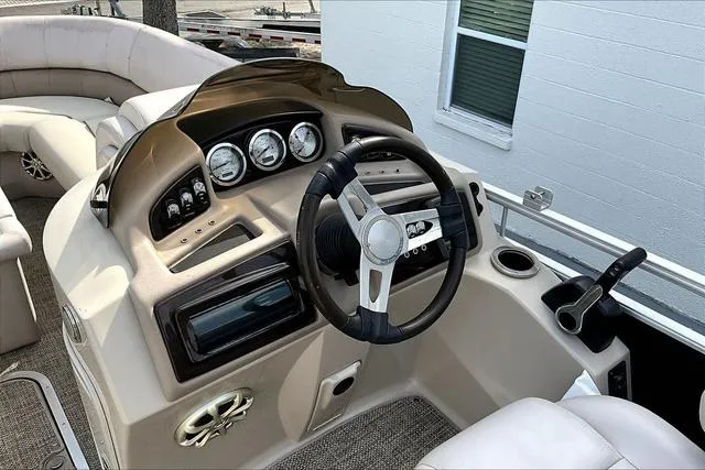 Slide: The Image of 2014 Bennington 2375 GCW boat dashboard with steering wheel and control panel. - 11