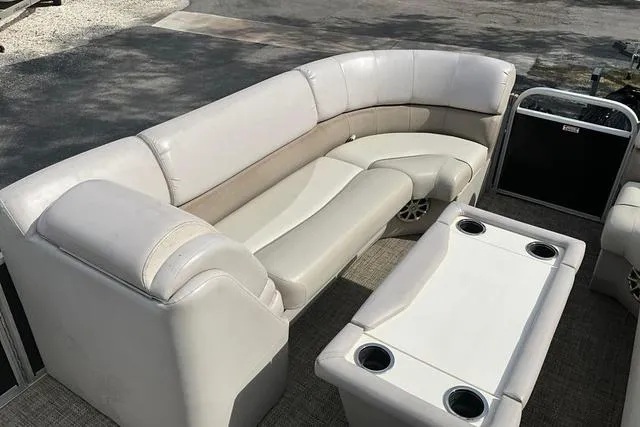 Slide: The Image of 2014 Bennington 2375 GCW pontoon boat interior with beige seating and table. - 19