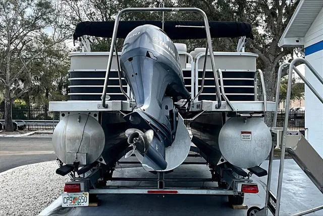 Slide: The Image of 2014 Bennington 2375 GCW pontoon boat on trailer, rear view with outboard motor. - 4