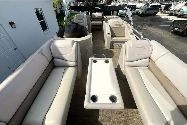 Slide: The Image of 2014 Bennington 2375 GCW pontoon boat interior with beige seating and table. - 8