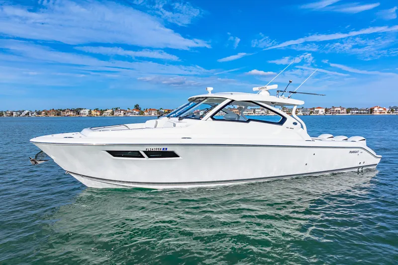 Slide: The Image of 2021 Pursuit DC 365 Dual Console boat on calm water, clear blue sky. - 0