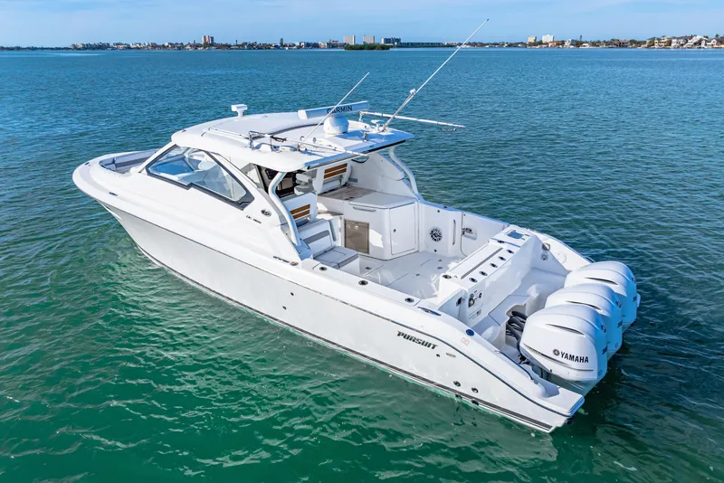 Slide: The Image of 2021 Pursuit DC 365 Dual Console boat on open water, featuring triple Yamaha engines. - 1