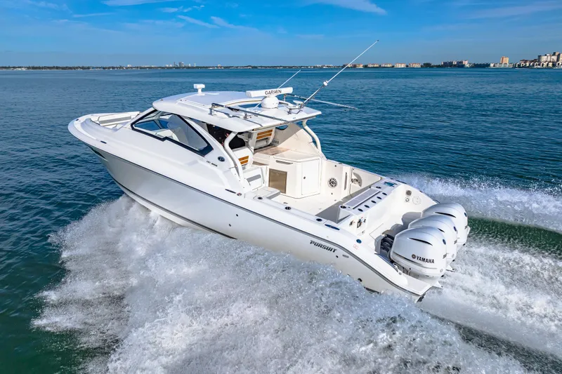 Slide: The Image of 2021 Pursuit DC 365 Dual Console boat cruising on open water. - 15
