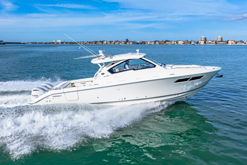 Slide: The Image of 2021 Pursuit DC 365 Dual Console boat cruising on open water. - 18