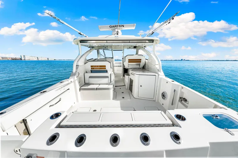 Slide: The Image of 2021 Pursuit DC 365 Dual Console boat on clear blue water. - 19