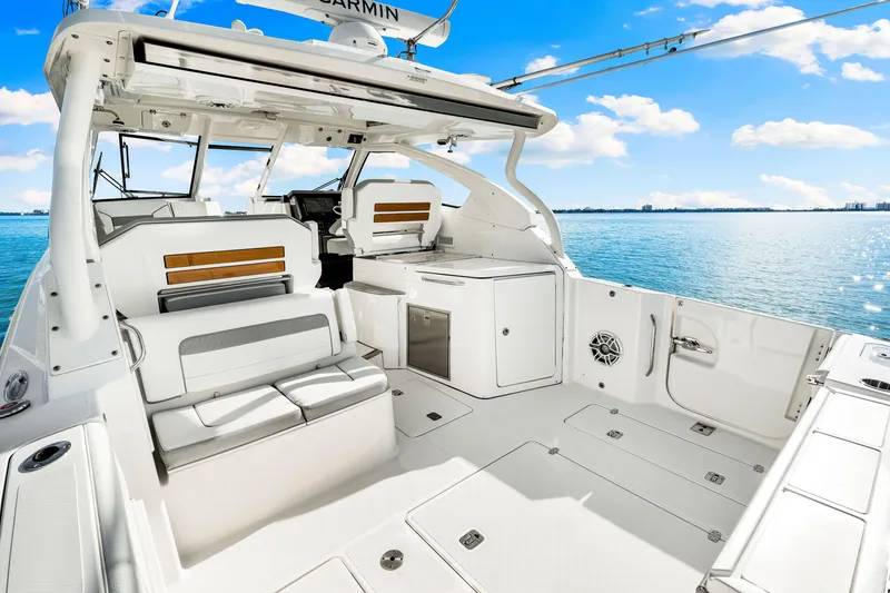 Slide: The Image of 2021 Pursuit DC 365 Dual Console boat interior on a sunny day at sea. - 21