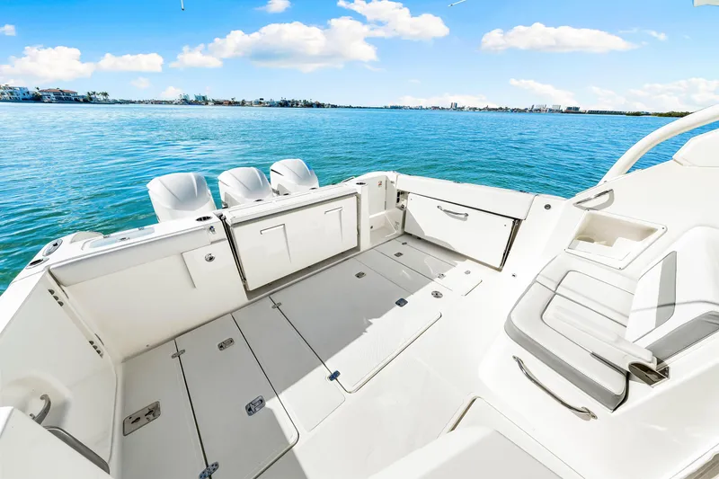 Slide: The Image of 2021 Pursuit DC 365 Dual Console boat interior with open deck and ocean view. - 23