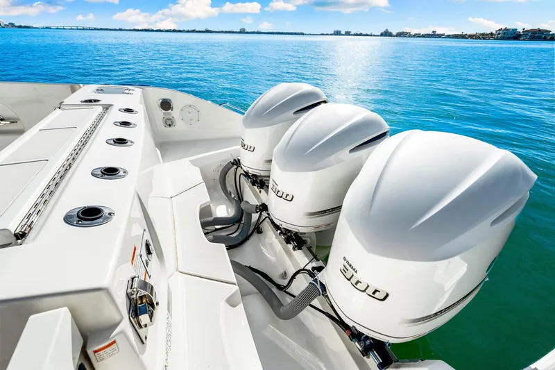 Slide: The Image of 2021 Pursuit DC 365 Dual Console boat with triple 300 horsepower engines on blue water. - 26