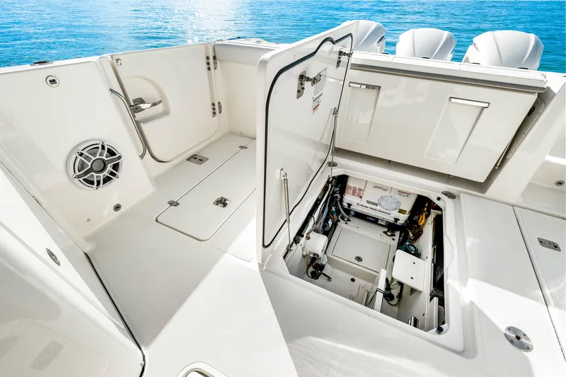 Slide: The Image of 2021 Pursuit DC 365 Dual Console boat interior with open storage compartment. - 27
