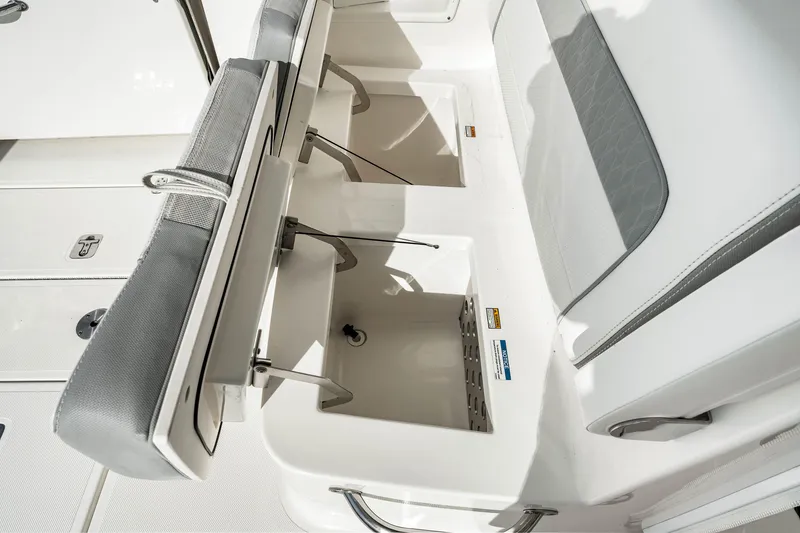 Slide: The Image of 2021 Pursuit DC 365 Dual Console boat seating and storage compartments. - 29