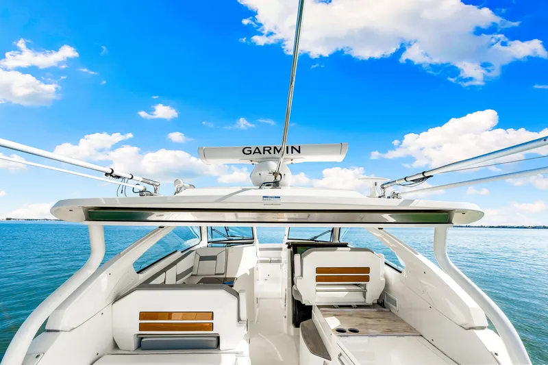 Slide: The Image of 2021 Pursuit DC 365 Dual Console boat on water under blue sky. - 31