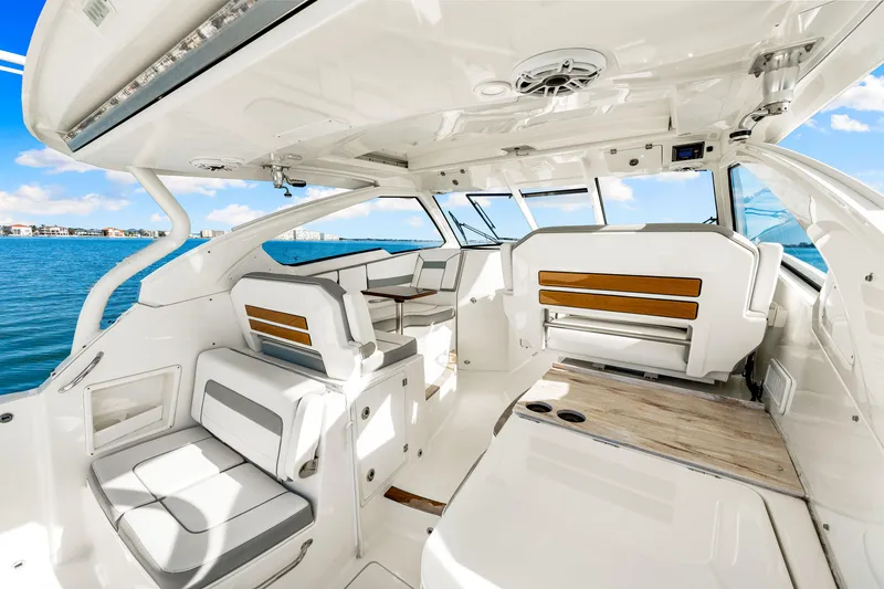 Slide: The Image of 2021 Pursuit DC 365 Dual Console boat interior with seating, ocean view, and modern design. - 32