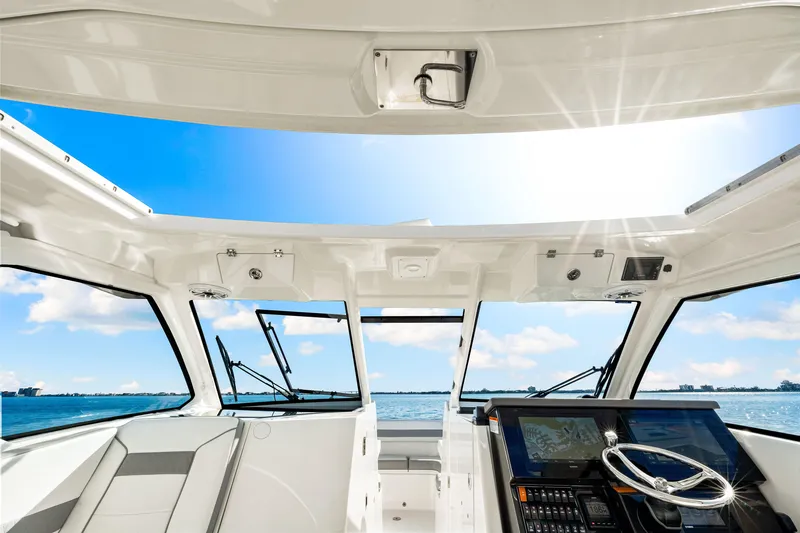 Slide: The Image of 2021 Pursuit DC 365 Dual Console boat interior with ocean view. - 40