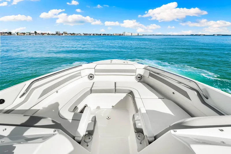 Slide: The Image of 2021 Pursuit DC 365 Dual Console boat on open water, clear skies, and distant shoreline. - 41
