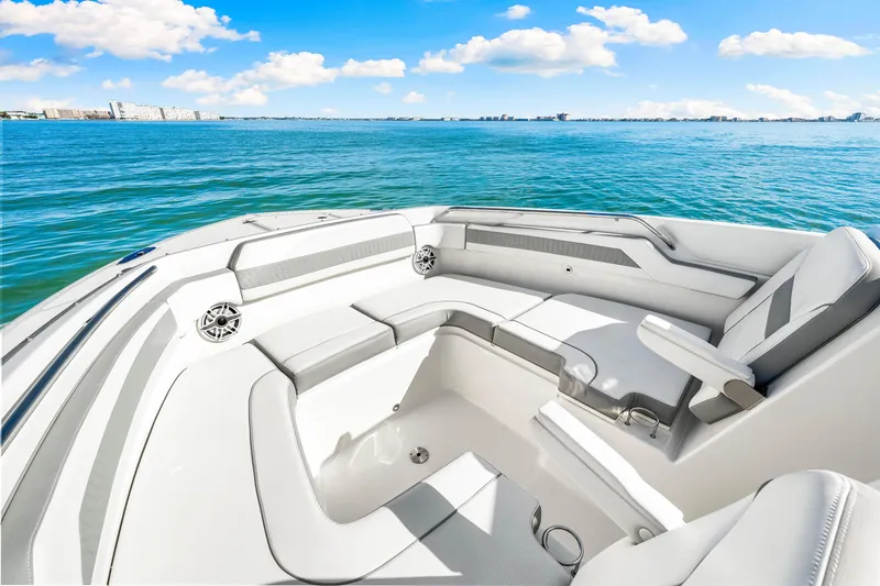 Slide: The Image of 2021 Pursuit DC 365 Dual Console boat interior with ocean view, featuring spacious seating. - 42