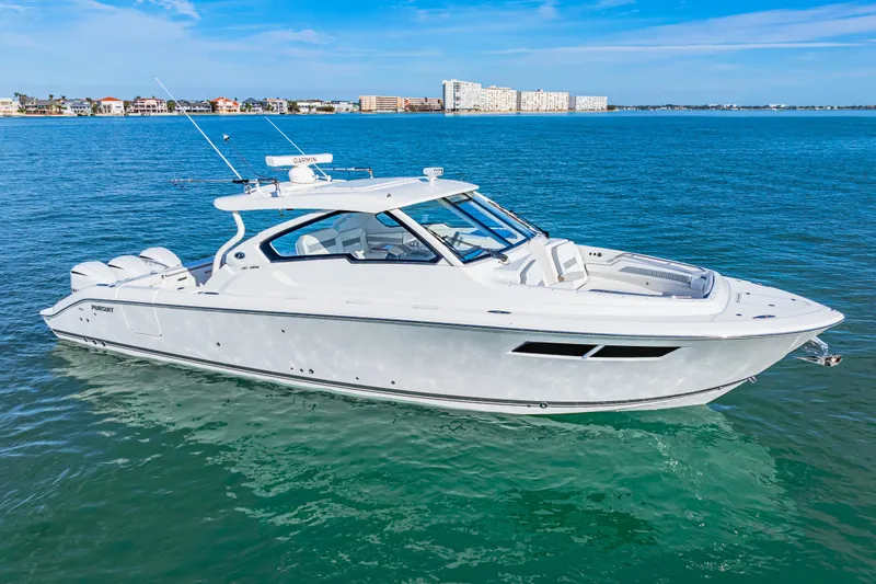 Slide: The Image of 2021 Pursuit DC 365 Dual Console boat on clear blue water. - 7