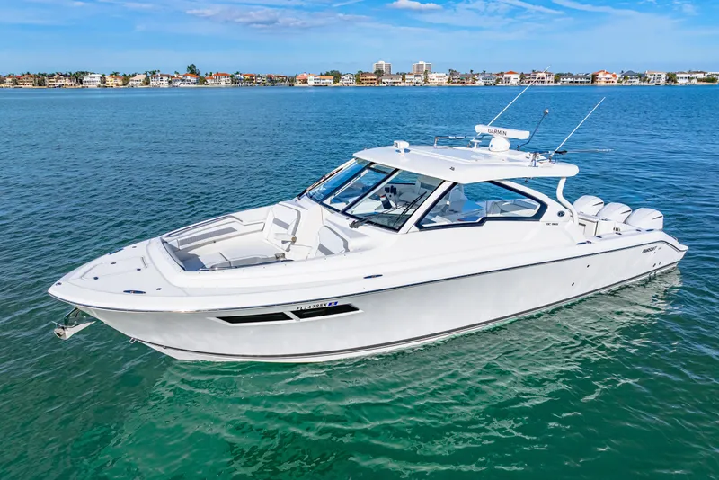 Slide: The Image of 2021 Pursuit DC 365 Dual Console boat on clear blue water. - 8