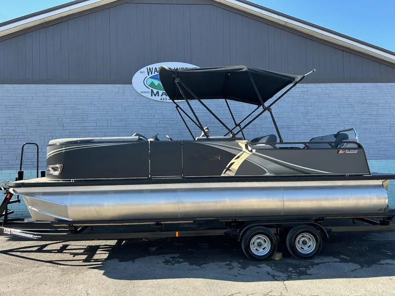 The Image of 2025 Avalon 2385 LSZ VRL pontoon boat on trailer, parked outside a building. - 1
