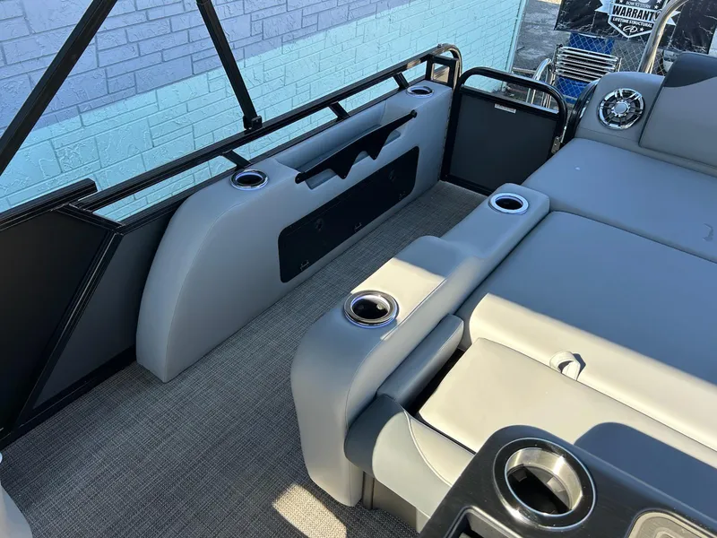 Slide: The Image of 2025 Avalon 2385 LSZ VRL boat interior with gray seating and cup holders. - 11
