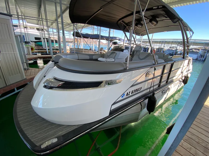 Slide: The Image of 2022 Montara 25 SURF BOSS 2.0 boat docked in a marina, featuring sleek design and spacious seating. - 10