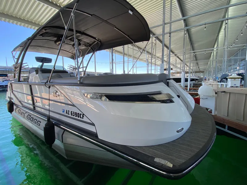 Slide: The Image of 2022 Montara 25 SURF BOSS 2.0 boat docked under a canopy. - 11