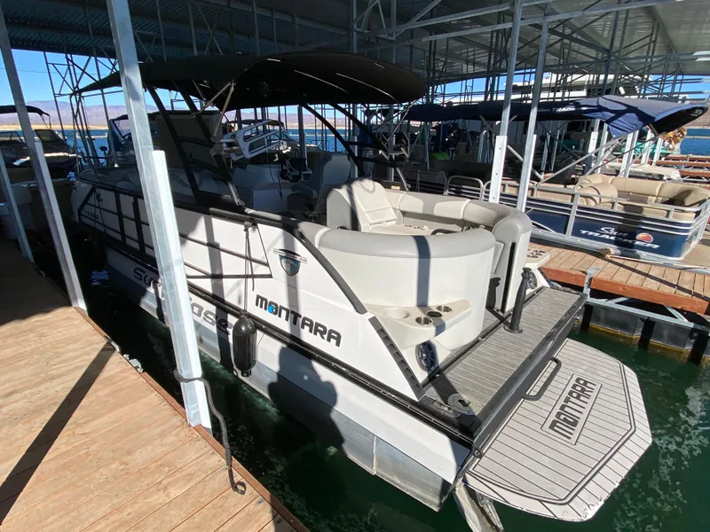 Slide: The Image of 2022 Montara 25 SURF BOSS 2.0 boat docked in marina, side view. - 12